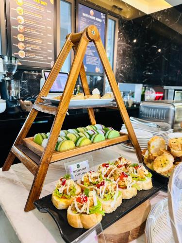a display of sandwiches and pastries on a table at Zazz Urban Ho Chi Minh in Ho Chi Minh City