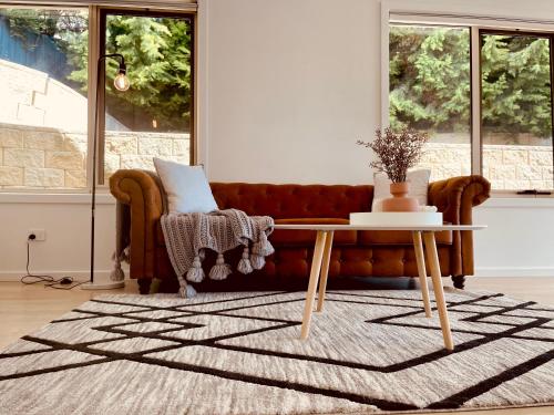 a living room with a couch and a table at Spacious 3 bedrooms family living in Rosetta in Rosetta