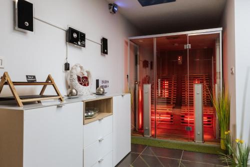 a kitchen with white cabinets and a glass door at Tanja s Holiday Home in Nature with sauna and hot tub in Gorica pri Slivnici