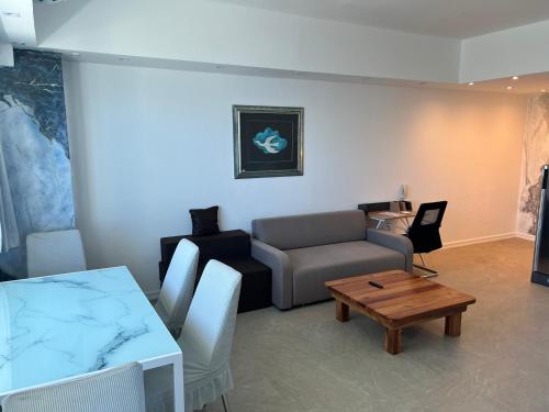 a living room with a couch and a table at La Mirada Residences Sea-view Suites in Mactan