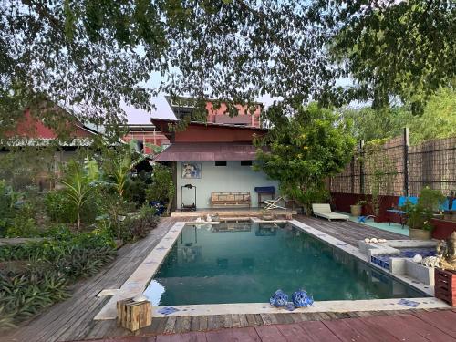 a swimming pool in the yard of a house at Blue Indigo yoga Cambodia in Phnom Penh