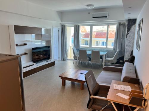 a living room with a couch and a table at La Mirada Residences Sea-view Suites in Mactan