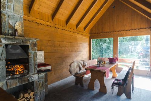 a living room with a fireplace and a table and a couch at Harenda Residence in Zakopane