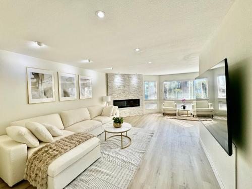 a living room with a white couch and a fireplace at Stunning apartment steps from Ocean Beach in San Francisco