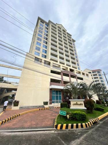 a tall building with a street in front of it at La Mirada Residences Sea-view Suites in Mactan