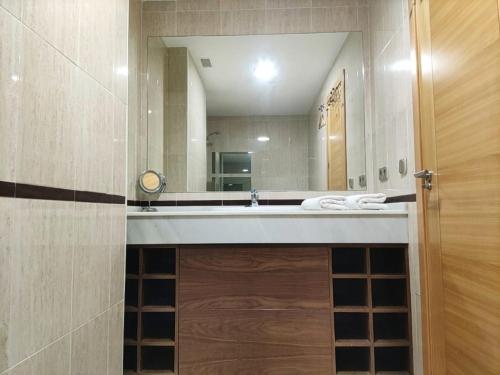 a bathroom with a sink and a large mirror at Refugio Racó del Conill - Mountain, Beach & Spa in Benidorm