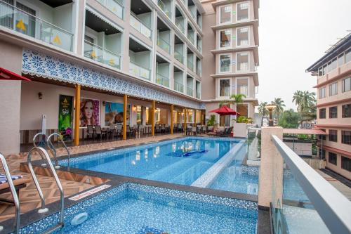 a swimming pool in the middle of a building at The Avenue Grand in Calangute