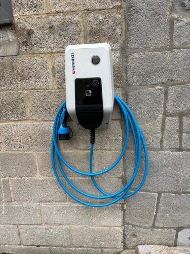 a blue hose is hooked up to a wall at La porte du paradis in La Roche Madoux