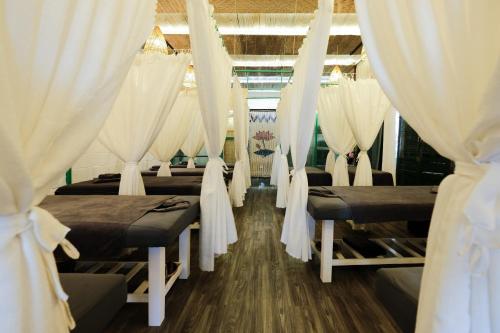 a row of beds in a room with curtains at LA ALBA VILLA AN BANg HOI AN in An Bang