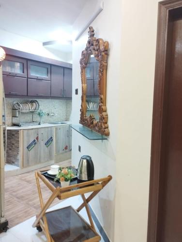 a mirror on a wall next to a table at Charming Home banglow in Karachi