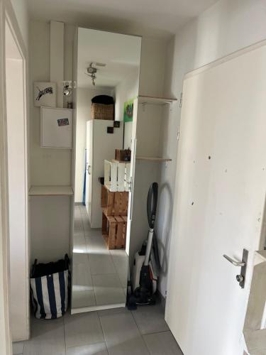 a kitchen with a refrigerator and a room with boxes at Lorraine in Bern