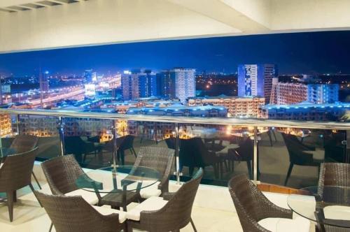 a restaurant with a view of a city at night at anuva residences in Manila