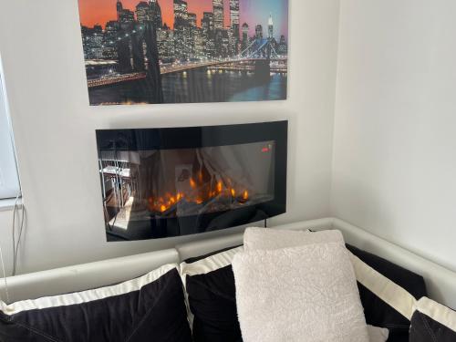 a fireplace in a living room with a view of a city at Apartman Vlašić Hary in Vlasic