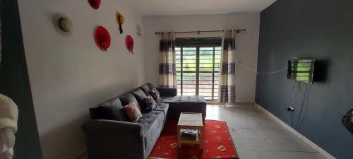 a living room with a couch and a table at Lavila. Fully furnished 2 bedroomed house. Located in busukuma, wakiso Uganda. in Gayaza