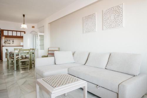 Sala de estar blanca con sofá blanco y mesa en Club Atlantis Aparthotel Ocean View, en Adeje