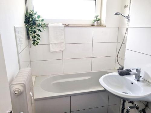 a bathroom with a bath tub and a sink at cozy Apartment with Balcony in Kronberg im Taunus