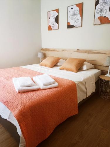 a bedroom with a bed with two towels on it at O. Li Apart Estoril in Estoril
