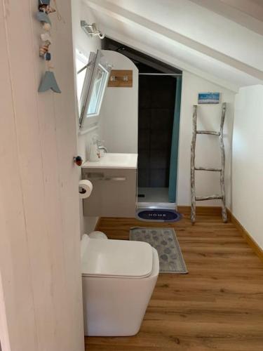 a small bathroom with a sink and a toilet at 'Impy' House in Finale Ligure