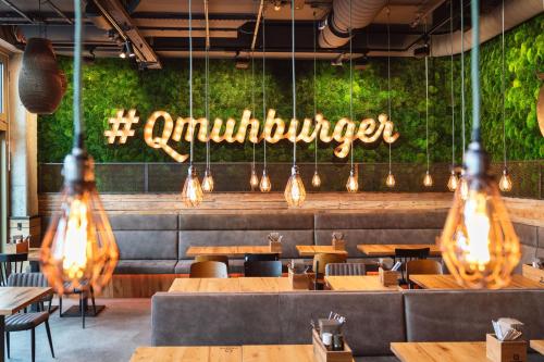 a restaurant with wooden tables and a sign that reads omnipresent at RiKu HOTEL Reutlingen in Reutlingen