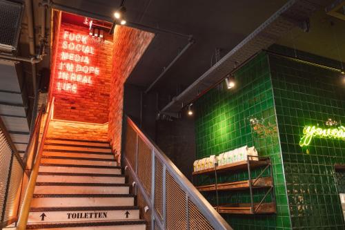 a set of stairs in a theatre with a green wall at RiKu HOTEL Reutlingen in Reutlingen