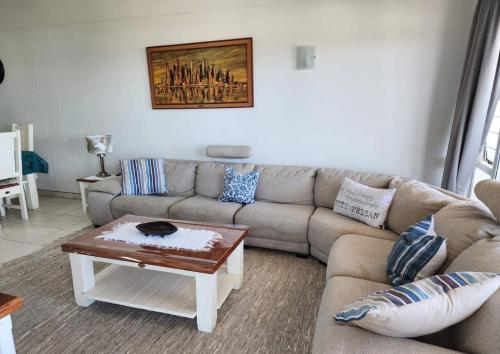 a living room with a couch and a coffee table at Casa Uvongo 110 in Uvongo Beach