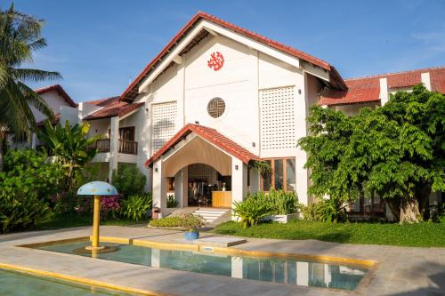 a building with a pool in front of it at Pax Ana Doc Let Resort & Spa in Ninh Hòa