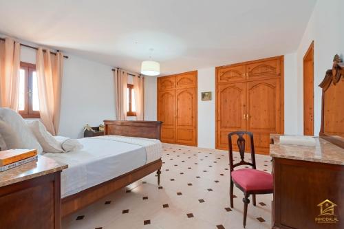 a bedroom with a bed and a desk and a chair at Villa Katerina in Benissa