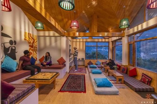 a group of people sitting in a living room at Zostel Old Manali in Manāli