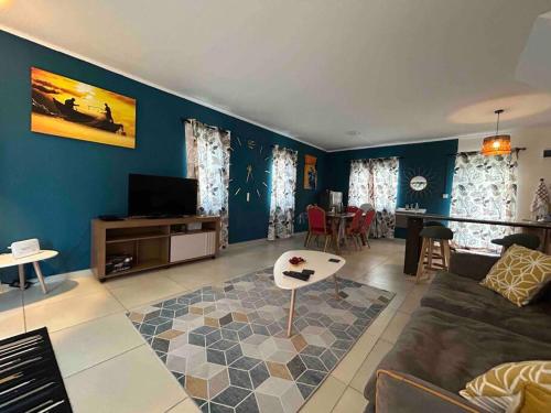 a living room with a couch and a table at North Mauritius New-built 2-bedroom Villa with shared pool in Grand Gaube