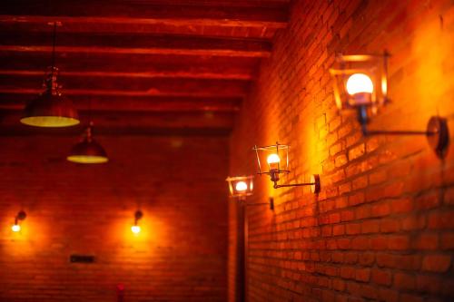 a room with lights on a brick wall at Royal Inn in Tbilisi City