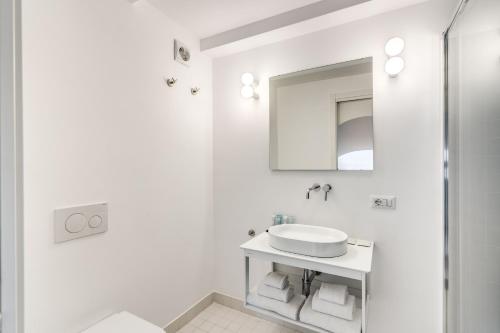 a white bathroom with a sink and a mirror at Villa Giulia Boutique Views Pool and Guest Services by Feeling Italy in Sorrento