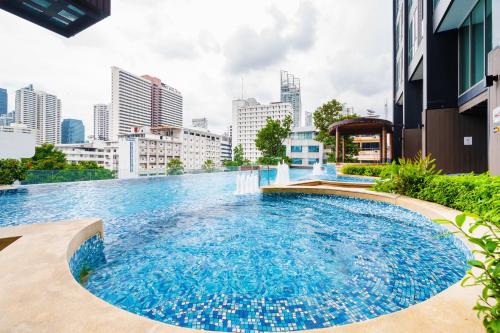 a swimming pool in the middle of a city at The Rich Residence Sukhumvit Nana in Bangkok