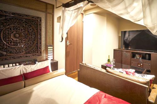 Łóżko lub łóżka w pokoju w obiekcie Hotel Bali An Resort Nambadotonbori