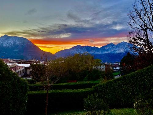 a view of a sunset with mountains in the background at VILLA MONTESOLE in Lecco