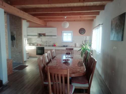 a kitchen and dining room with a table and chairs at Kuća za odmor Lika in Gospić