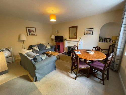 a living room with a table and a couch at The Fiddichside Inn in Aberlour