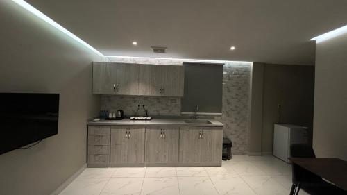 a kitchen with a sink and a counter top at لاقونا للشقق المخدومة in Al Ahsa