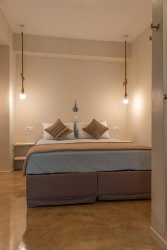 a bedroom with a large bed with lights on it at Manus Dei Exclusive Suites in Pythagoreio