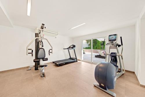 a gym with several exercise equipment in a room at Hotel Cala Dor - Adults Only in Cala d´Or