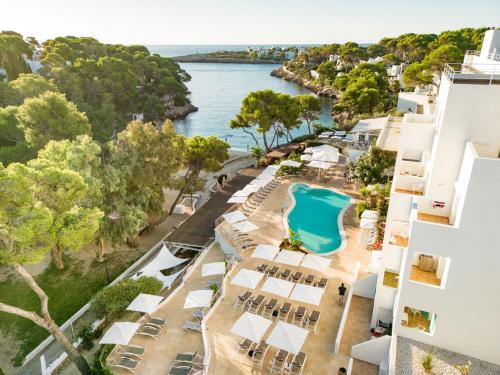 an aerial view of the hotel and the water at Hotel Cala Dor - Adults Only in Cala d´Or