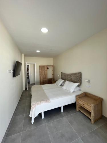 a bedroom with a large bed and a television at Arena Sunrise - Sea View and Main Street in Corralejo