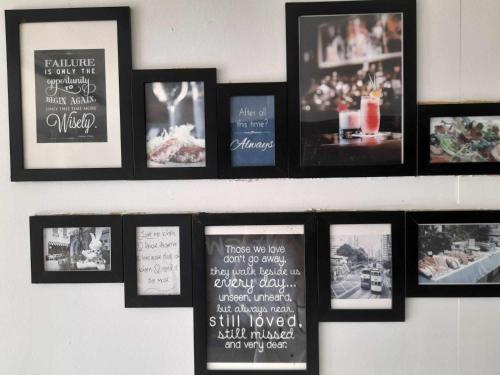 a shelf with framed pictures on a wall at SP.Place Hotel Koh Chang in Ko Chang