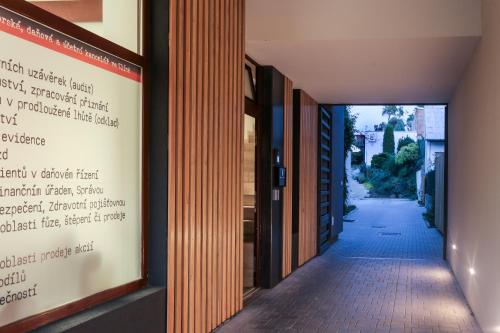 a hallway with a sign on the side of a building at Pár pokojů microhotel in Zlín