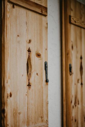 a wooden door with a hole in it at Salzbergalm in Berchtesgaden