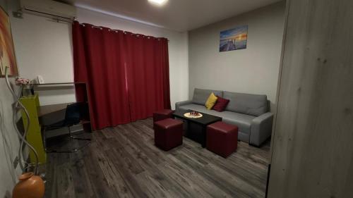 a living room with a couch and a red curtain at Apartment in central Bucharest in Bucharest