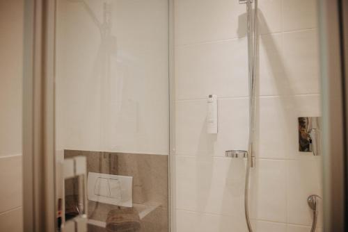 a shower with a glass door in a bathroom at Salzbergalm in Berchtesgaden