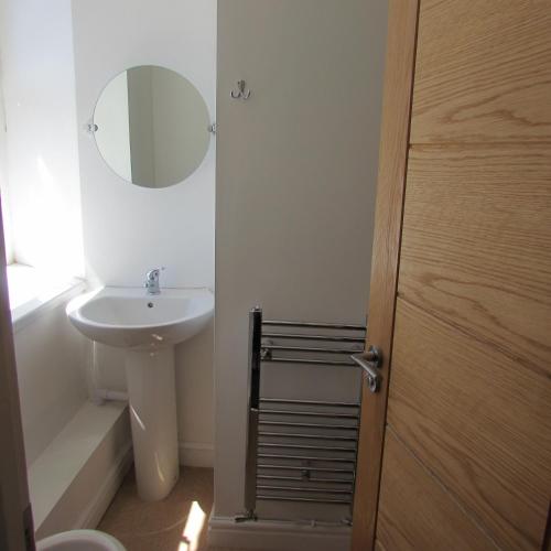 a bathroom with a sink and a mirror at Lord Nelson Hotel in Rhymney