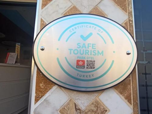 a sign for a safe tourism sign on a wall at Samsun Park Hotel in Samsun