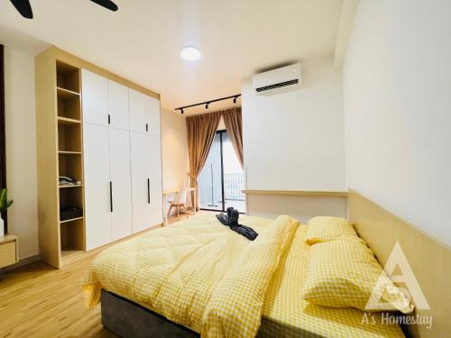 a bedroom with a large bed with a yellow blanket at Netizen Soho 2pax MRT Cheras Wi-Fi VsHome in Cheras