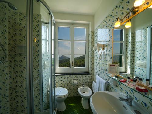 a bathroom with a sink and a toilet and a shower at Hotel Scapolatiello in Cava deʼ Tirreni